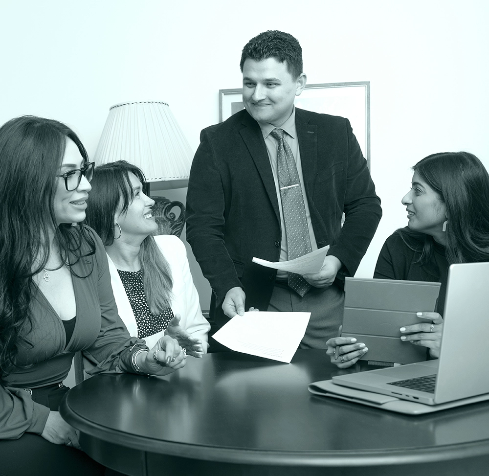 The True Team collaborating around a table, supporting purpose-driven leaders in sustainability and community impact.